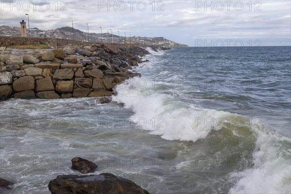 Strong swells during storm break on seawall in Sanremo