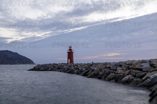 Sunrise with lighthouse at the harbour pier in Porto Maurizio