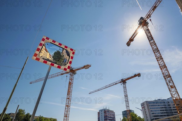 Cranes and concave mirrors at construction site on Orleanstr. Munich