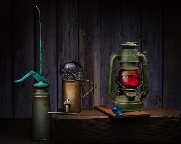 Still life with old oil cans. Glass balls