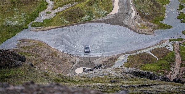 Car drives through ford at Landmannalaugar Camp