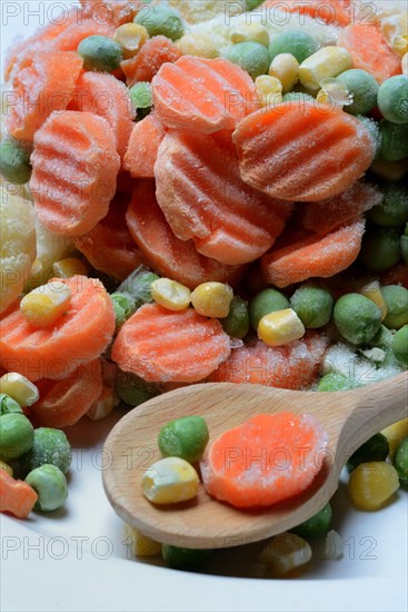 Frozen vegetables with cooking spoon