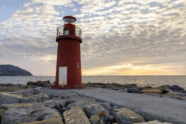 Sunrise with lighthouse at the harbour pier in Porto Maurizio