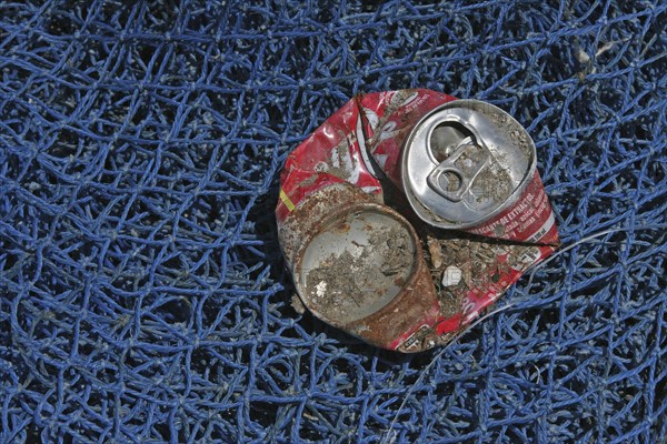 Crushed Coke Can on Blue Fishing Net