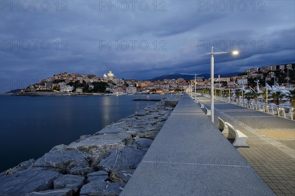 Sunrise with lighthouse at the harbour pier in Porto Maurizio