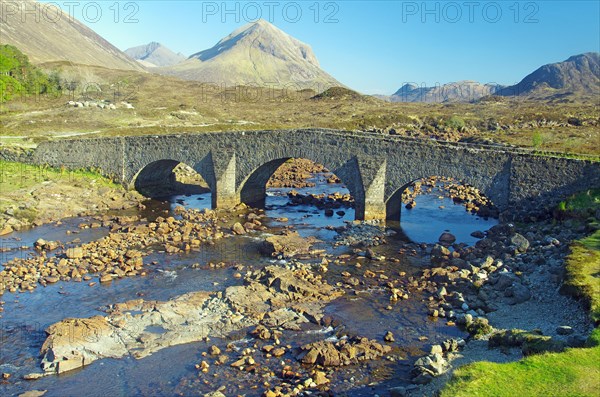 Old stone bridge leading over a stream