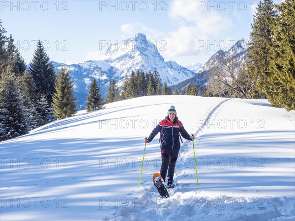 Snowshoe hiker in winter landscape