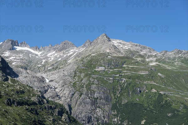 Mountain massif of the Rhone glacier with serpentines of the Furka Pass road