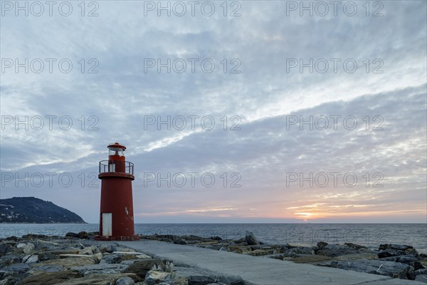 Sunrise with lighthouse at the harbour pier in Porto Maurizio