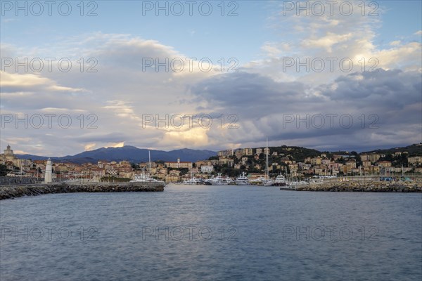 Sunrise with lighthouse at the harbour pier in Porto Maurizio