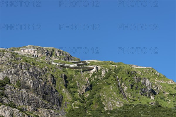 Mountain massif of the Rhone glacier with serpentines of the Furka Pass road