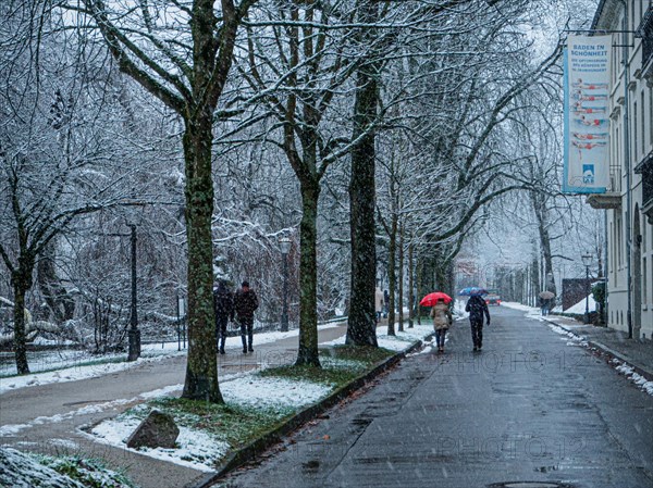 People with umbrella during snowfall