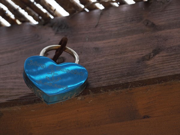 Love lock on wooden wall of gay couple