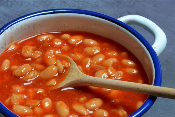 White beans with tomato sauce in pot