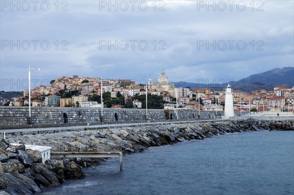 Sunrise with lighthouse at the harbour pier in Porto Maurizio