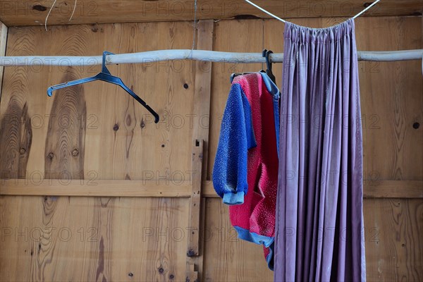 Empty wooden cupboard with curtain