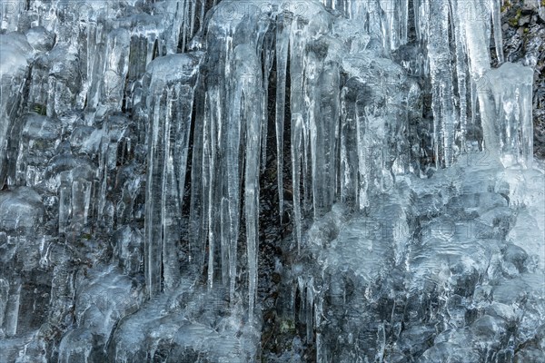 Icicles forming an icefall in the mountain in winter. France