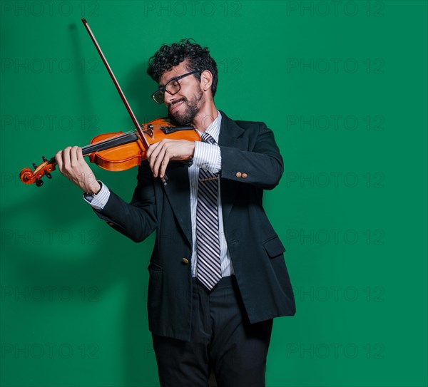 Attractive young man playing violin