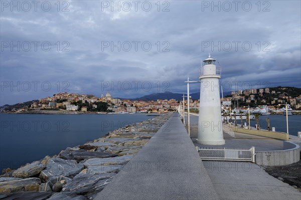 Sunrise with lighthouse at the harbour pier in Porto Maurizio