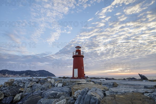 Sunrise with lighthouse at the harbour pier in Porto Maurizio