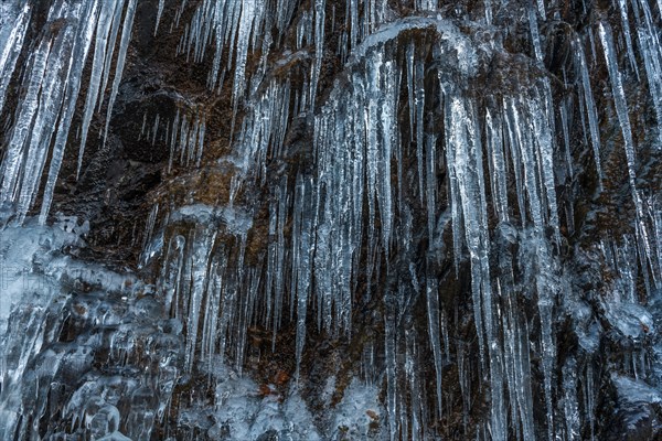 Icicles forming an icefall in the mountain in winter. France