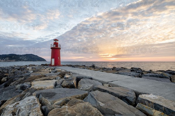Sunrise with lighthouse at the harbour pier in Porto Maurizio