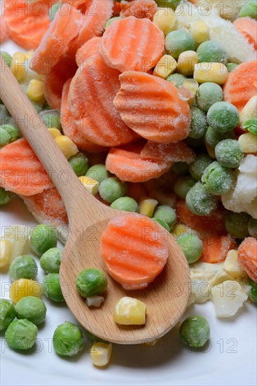 Frozen vegetables with cooking spoon