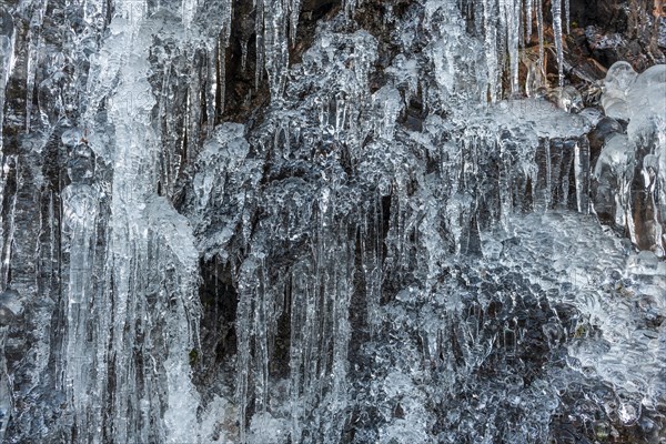 Icicles forming an icefall in the mountain in winter. France