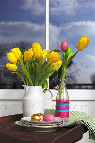 Bouquet of tulips and Easter eggs on a balcony