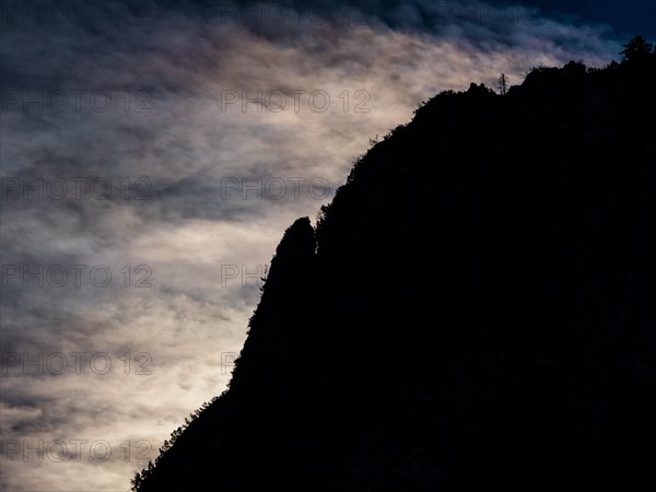 Clouds over mountain silhouette