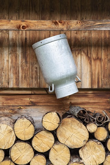 Milk can hung on the wall of an alpine hut