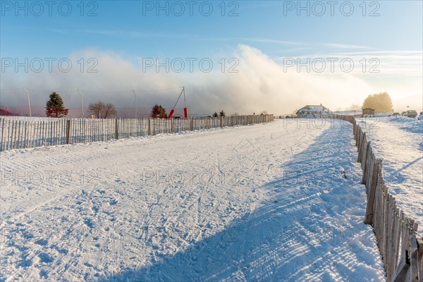 Cross-country ski trail in the snowy mountain on a sunny day. France