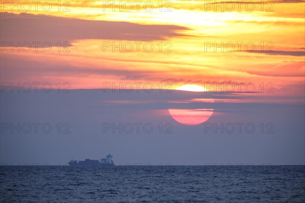 Sunrise with container ship on the Mediterranean Sea in Porto Maurizio