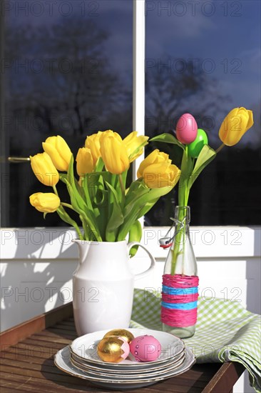 Bouquet of tulips and Easter eggs on a balcony