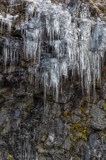 Icicles forming an icefall in the mountain in winter. France