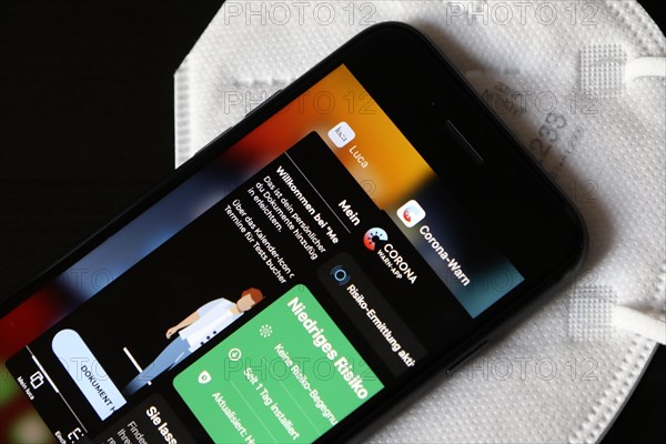 FFP2 mask and iPhone with Corona warning app and Luca app