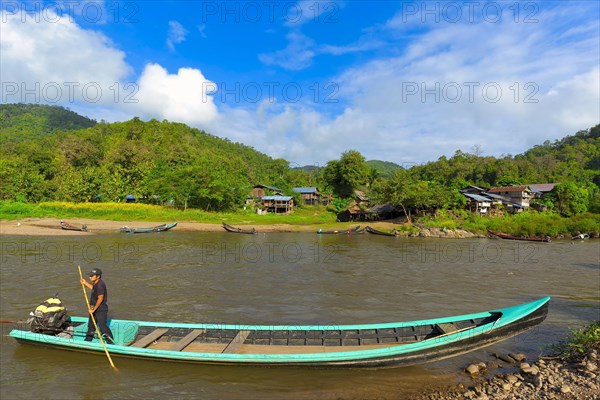 A longboat with a car engine on the Pai River