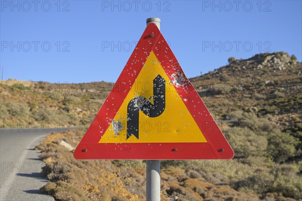 Shattered road sign