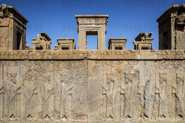 Persian guards at the west staircase of Darius Palace with cuneiform writing