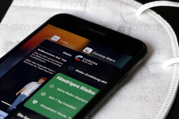 FFP2 mask and iPhone with Corona warning app and Luca app