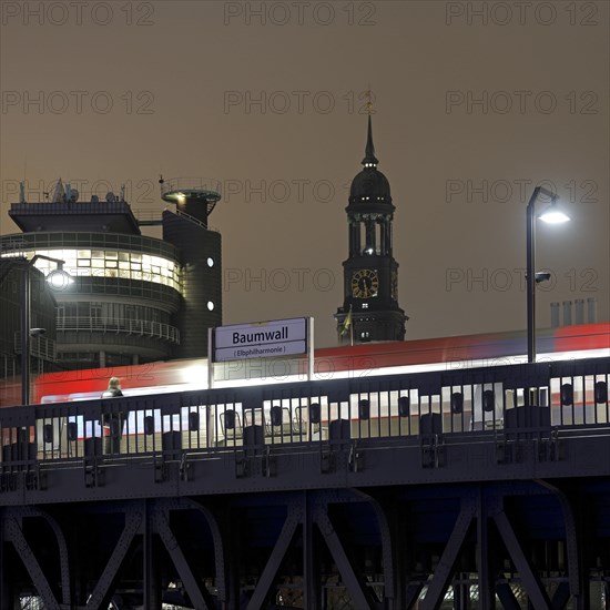 Baumwall underground station with the spire of St Michaelis church at night