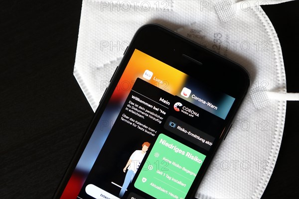 FFP2 mask and iPhone with Corona warning app and Luca app