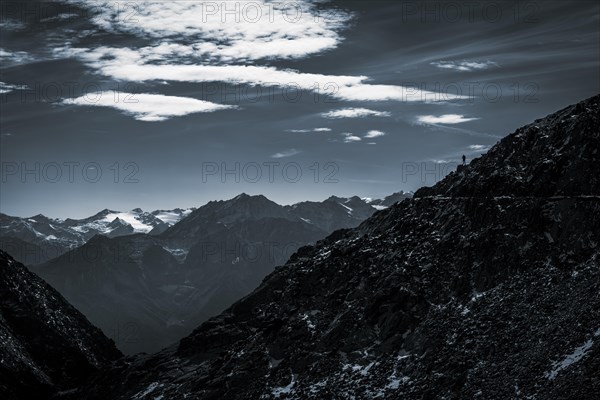 Mountaineers on mountain ridge in the background glaciated mountains