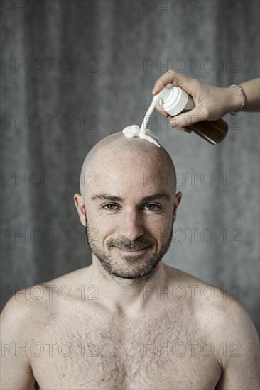 Man gets shaving foam sprayed on his bald head