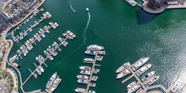 Dubai Marina and Harbour luxury wealth holiday with boats yacht from above panorama in Dubai