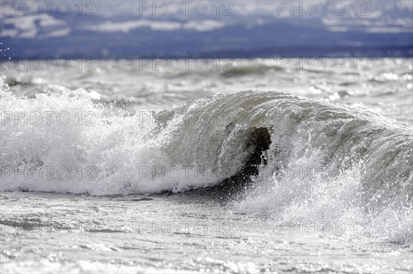 Storm Lolita raging on the rocky shore with waves in Hagnau