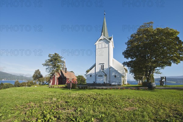 Kvernes Stave Church next to newly built church