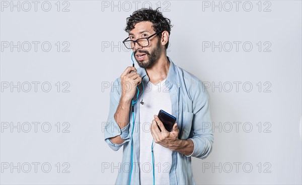 Handsome man talking with headset holding cellphone