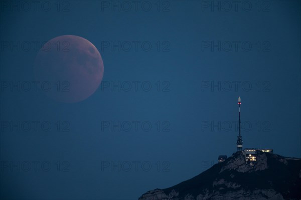 Lunar eclipse above the mountain station of Hohen Kasten