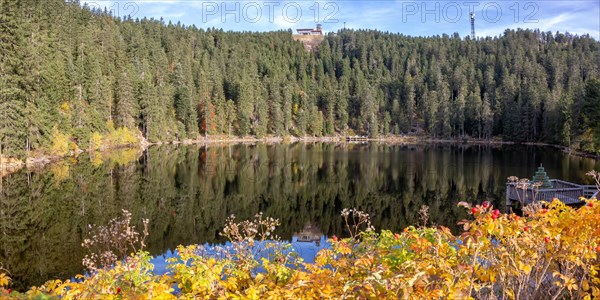 Mummelsee and mountain Hornisgrinde in Black Forest landscape nature in autumn panorama in Seebach